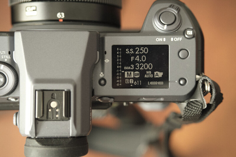 Top-down view of a camera's LCD screen displaying exposure settings including shutter speed, aperture, and ISO.