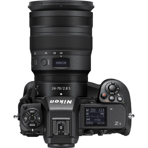 Top-down view of a mirrorless camera with 24-70mm zoom lens and control dial visible.