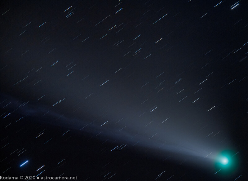 Comet with bright cyan coma and dust tail streaking across starfield with motion blur trails.