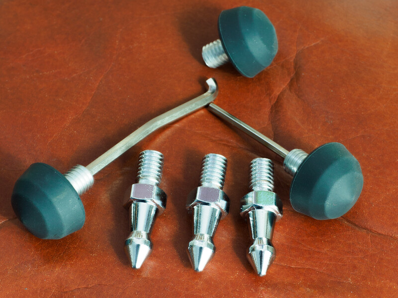 Studio flash trigger system with three wireless receivers and two remote transmitters on rust-colored surface.