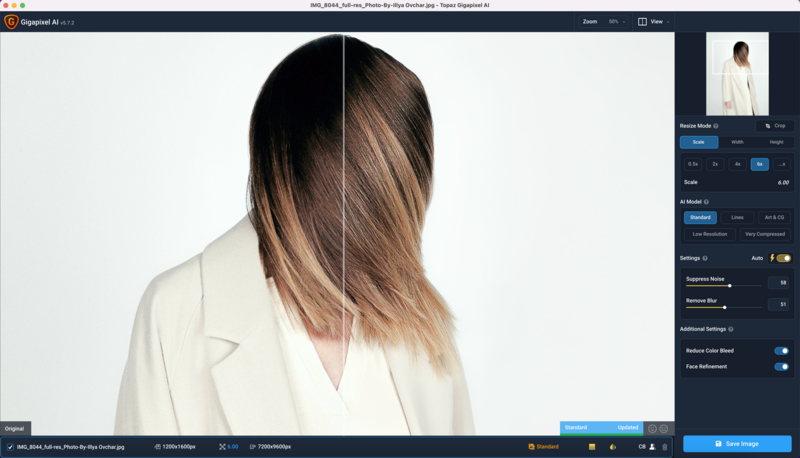 Woman wearing cream blazer photographed from behind, showing hair and shoulder detail against white background.