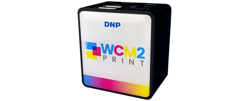 DNP WCM2 Print photo printer with black exterior and colorful gradient branding on front panel.