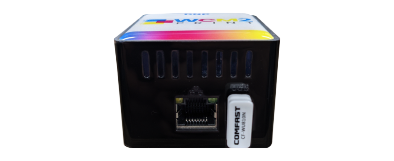 Back view of a compact network device with ethernet port and white connector label visible against black housing.