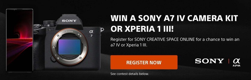 Sony A7 IV mirrorless camera body with orange accent ring displayed next to Xperia smartphone showing red abstract wallpaper.
