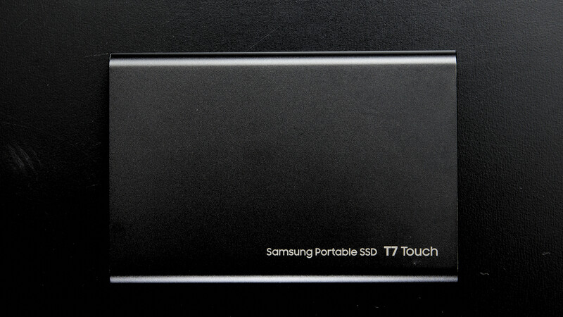 Samsung Portable SSD T7 Touch external drive displayed against dark textured background.