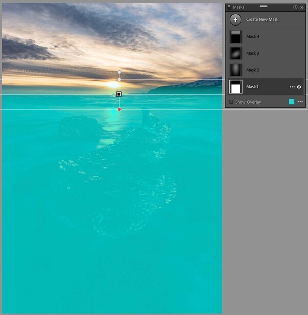 Split-frame underwater photograph showing sunset sky above water and turquoise ocean below.