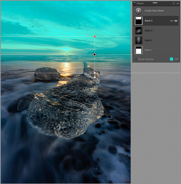 Coastal landscape with turquoise water, rocky formations, and golden sunset reflected in wet sand.