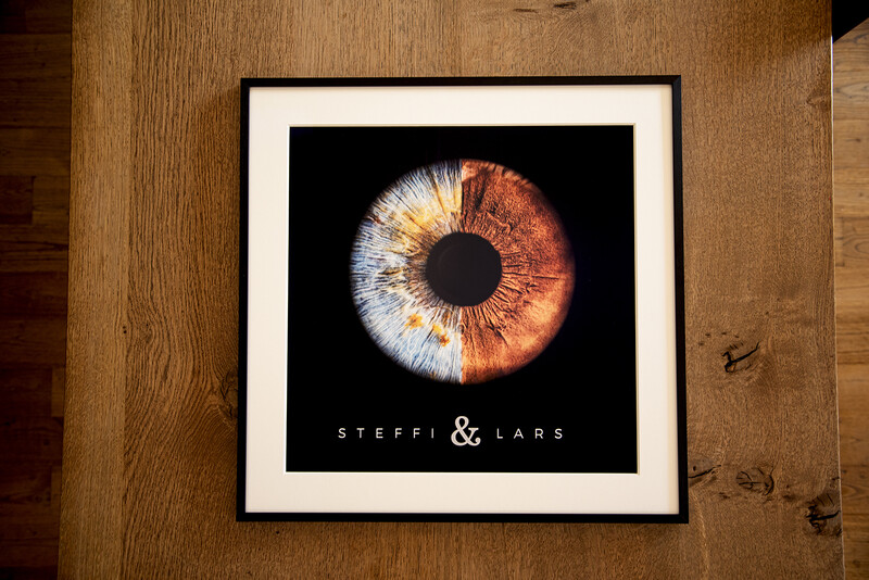 Framed poster featuring a close-up iris photograph with golden-orange and white tones against black background.