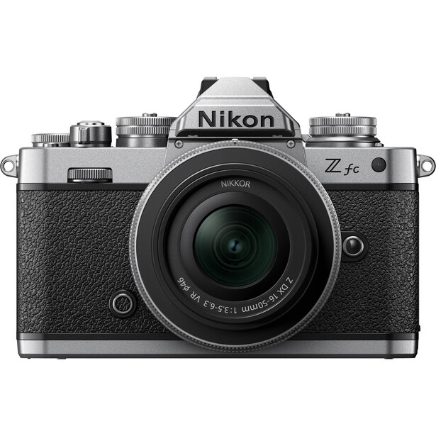 Nikon Z fc mirrorless camera with 28mm f/2.8 lens in silver and black, shot front-on against white background.
