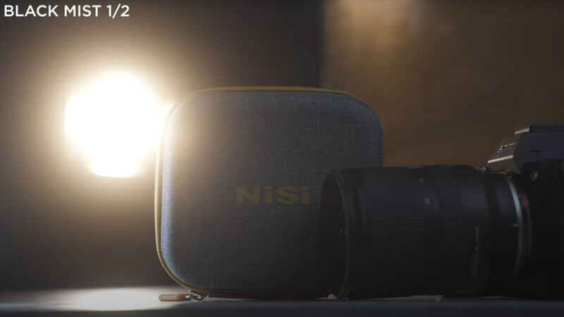 Black Mist filter in carrying case with camera lens against bright backlit light source.