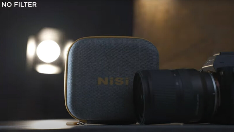 NiSi filter case and camera lens displayed with studio lighting in the background.
