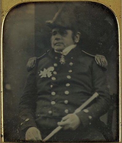 Daguerreotype portrait of a military officer in double-breasted uniform with epaulettes, holding a scroll or document.
