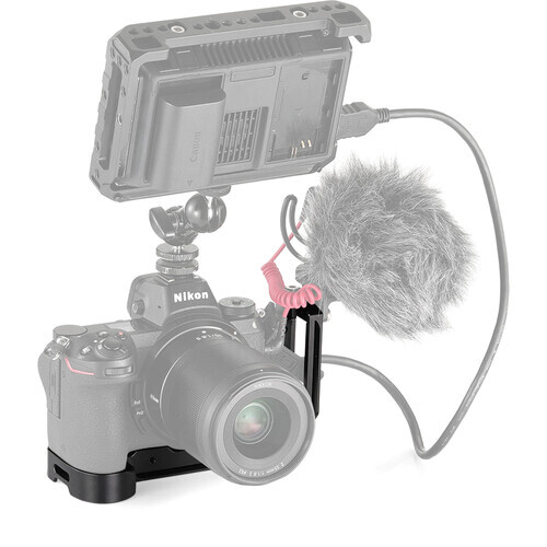 Illustration of a DSLR camera with mounted microphone and monitor for video production.