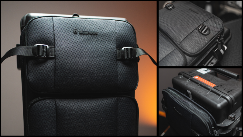 Black camera bag with quilted pattern and side carry straps displayed against warm orange lighting.