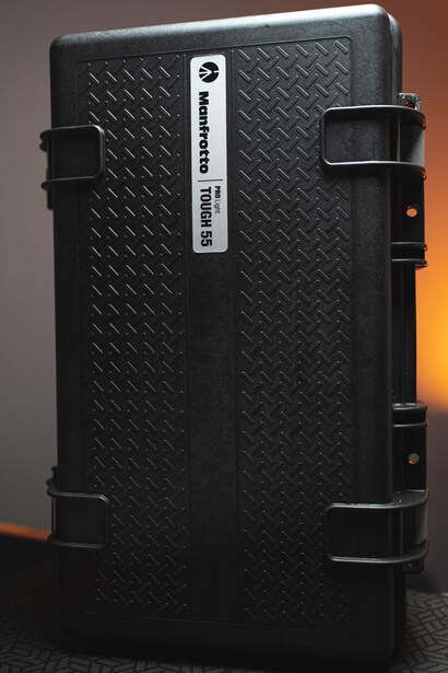Black protective equipment case with diamond plate texture and latching handles.