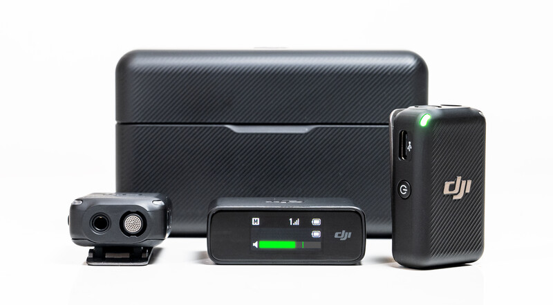 DJI drone accessories including a compact drone, remote controller, battery, and charging case arranged on white background.