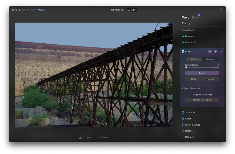 Screenshot of photo editing software showing a steel trestle bridge spanning a desert canyon landscape.