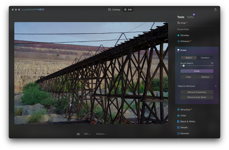 Screenshot of Luminar Neo editing software displaying a weathered wooden trestle bridge spanning a canyon landscape.