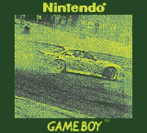 Game Boy screenshot showing pixelated yellow and green racing car on track.