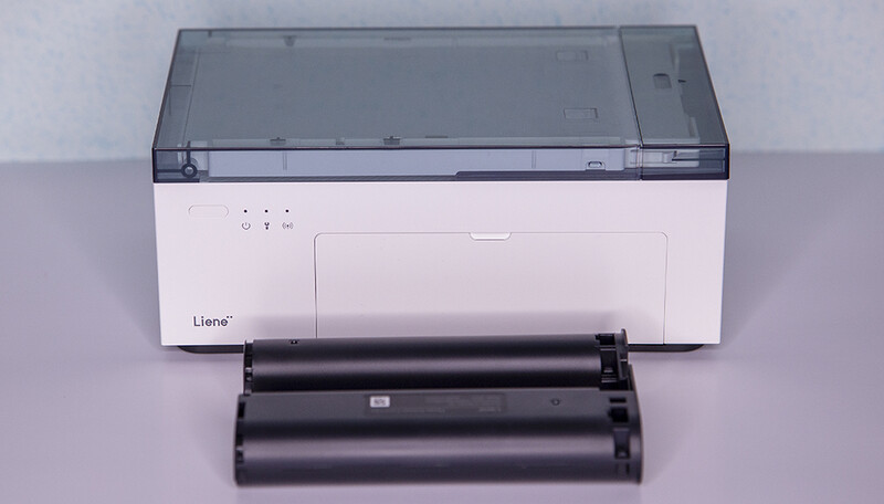 The Liene Photo Printer in storage mode, with it's case for paper neatly fitting up top. Up front is one of the Liene's printing cartridges.