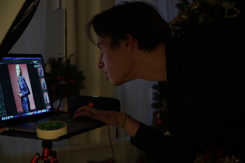 Photographer reviewing fashion imagery on a laptop screen during an editing session.