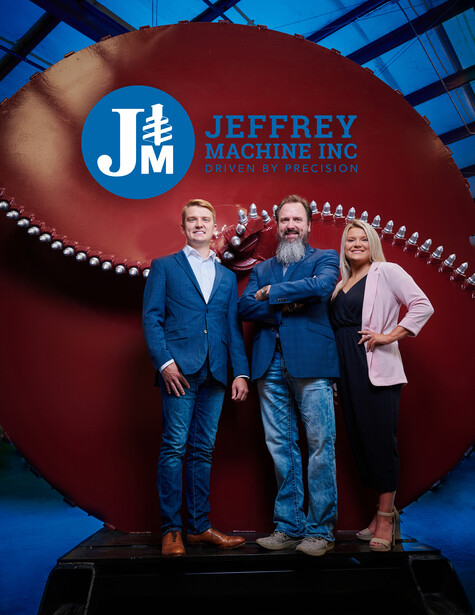 People standing in front of a logo