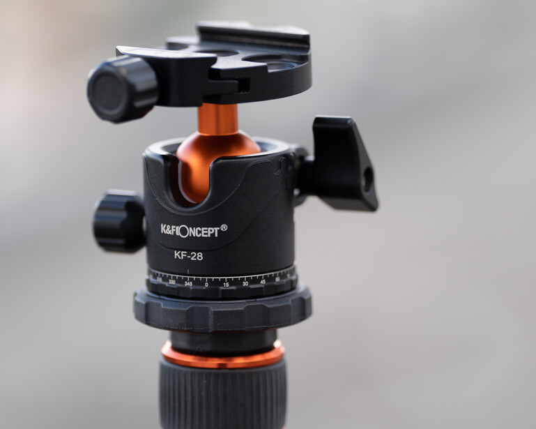 Kapconcept KF-28 ball head with black and orange design mounted on tripod leg.