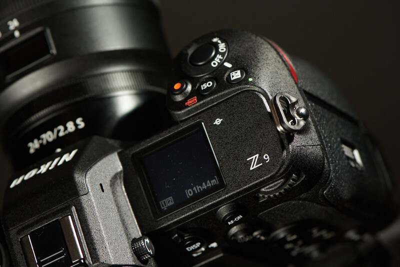Nikon Z9 mirrorless camera with attached telephoto lens, shot from above against dark background.