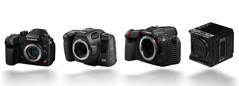 Four professional digital cameras displayed in a row against a white background.