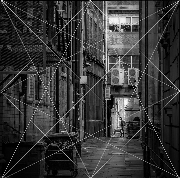 Narrow urban alley framed by geometric line overlays creating a symmetrical composition.