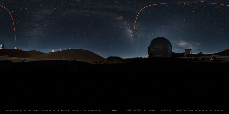 Observatory silhouettes against starry night sky with Milky Way visible and light trails arcing overhead.
