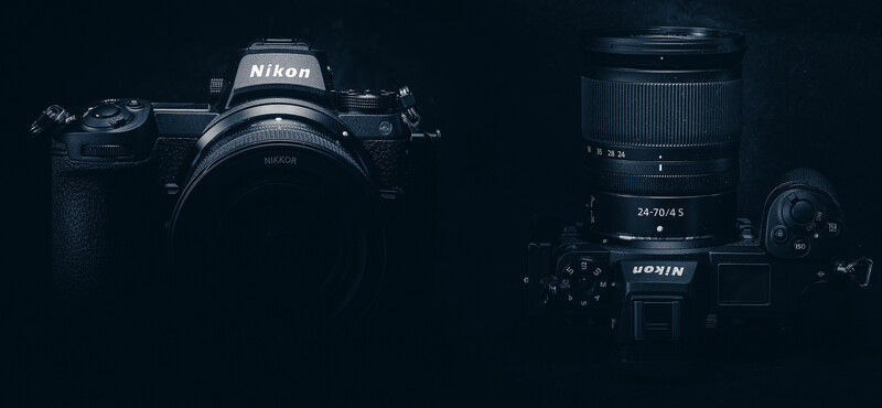 Nikon Z9 mirrorless camera body with Nikkor Z 24-70mm f/4.5 lens and accessories on dark background.