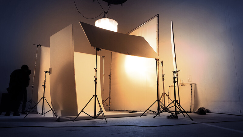 Professional photography studio setup with large softbox and lighting equipment on tripod stands.
