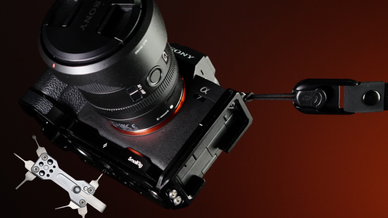 Sony mirrorless camera with lens mounted on black rig plate against warm brown background.