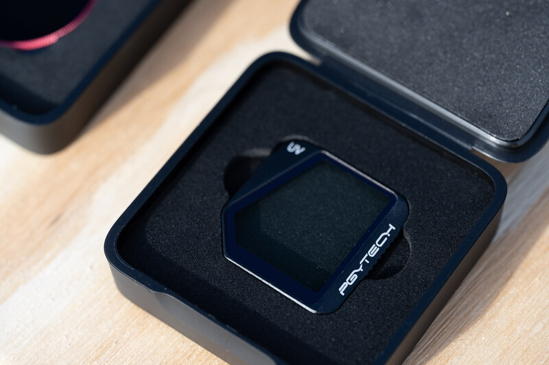 Smartwatch with dark display sitting in a black presentation box lined with black foam padding.