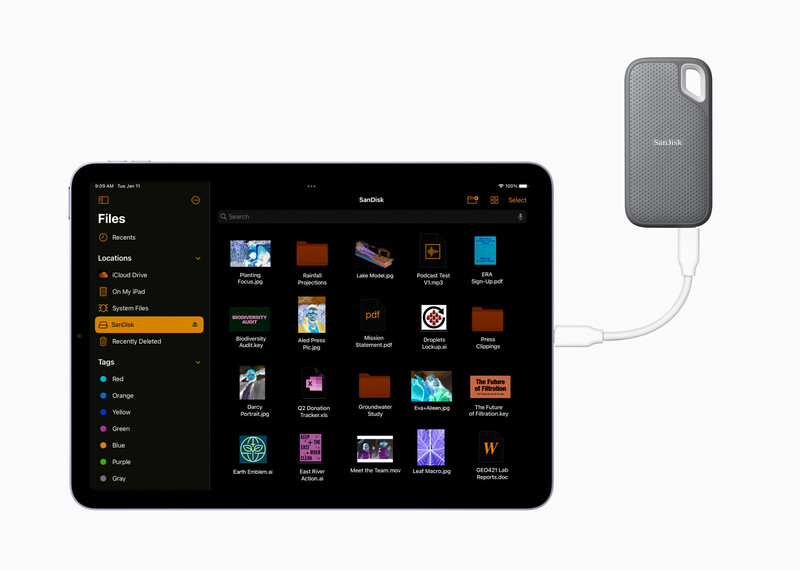 Screenshot showing a tablet displaying a file management interface with media thumbnails connected to an external portable storage device.