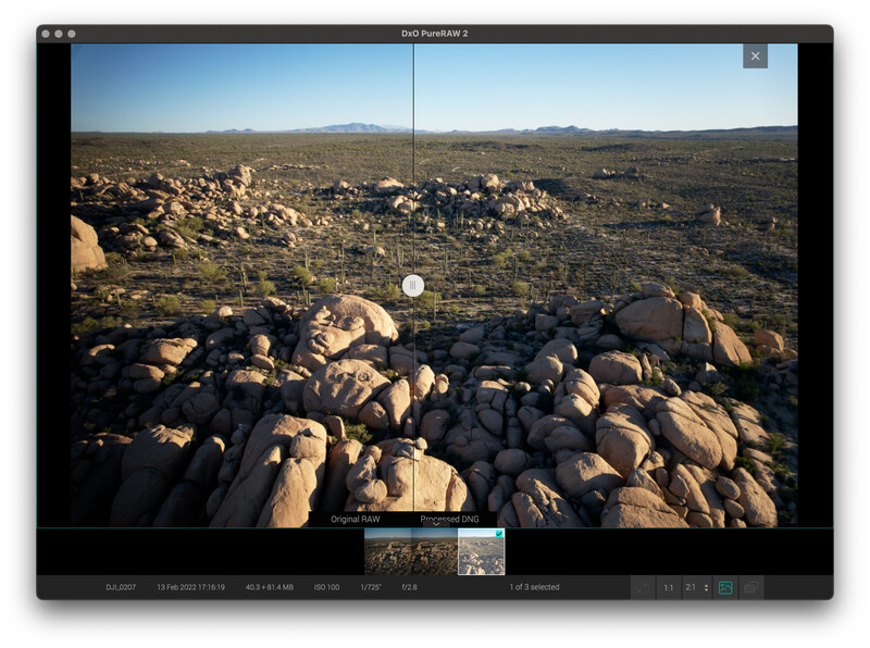 Screenshot of image editing software displaying a desert landscape with scattered boulders under clear sky.