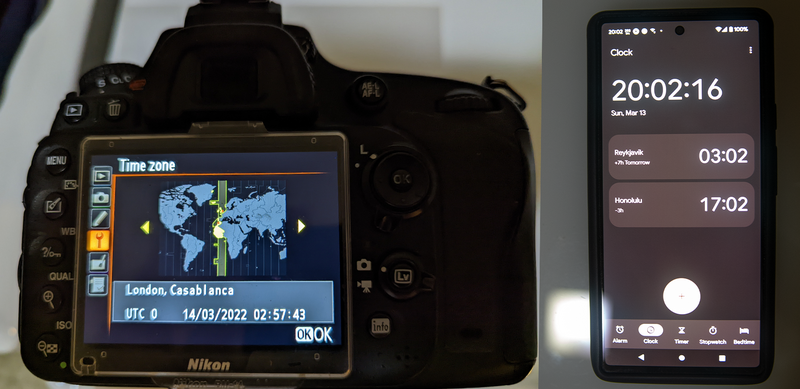 Nikon DSLR camera displaying world time zone menu alongside smartphone showing clock app.