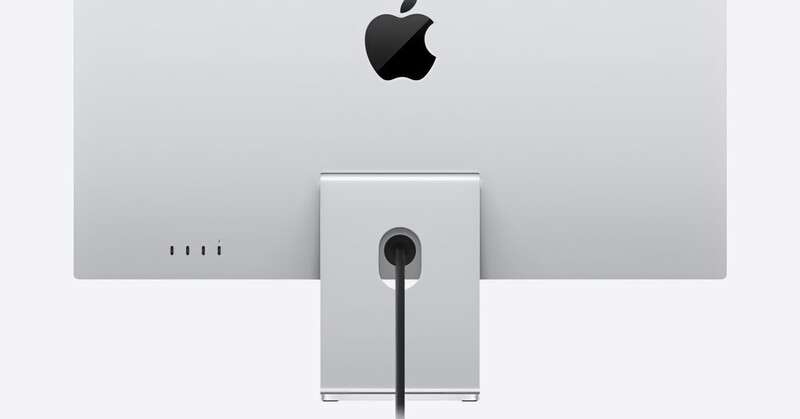 Apple iMac viewed from behind, showing the silver aluminum frame and power cable against a neutral background.