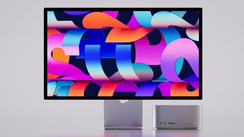 Apple Studio Display monitor shown from front and side angles with colorful abstract 3D gradient artwork on screen.
