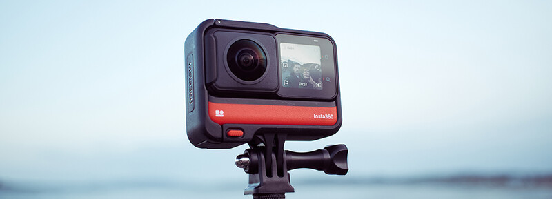 Insta360 action camera mounted on a tripod overlooking a calm body of water.