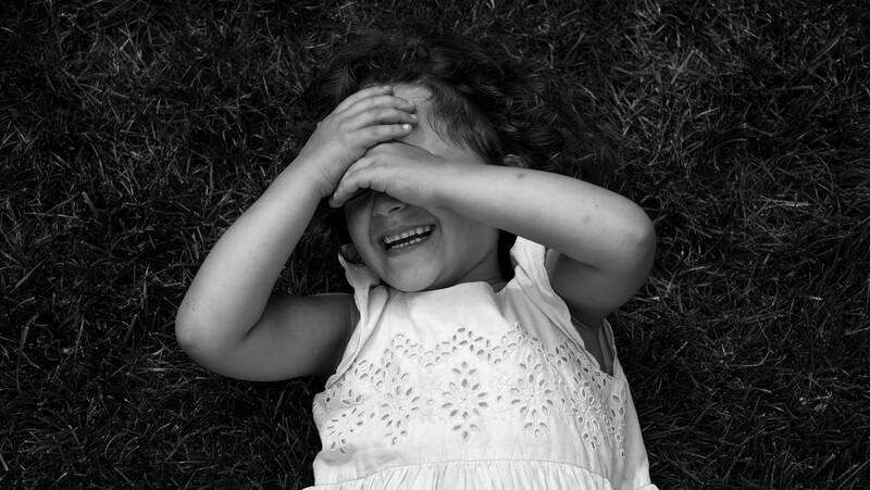 Kid in the grass taken with a Fuji X-Pro1 and 35mm 
