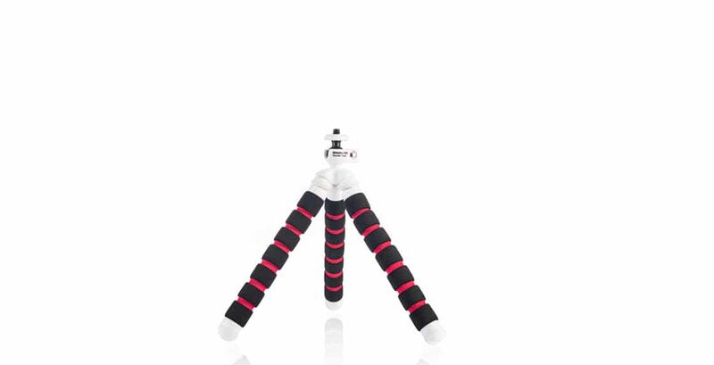 Compact tripod with black and red striped foam legs and white mount head against white background.