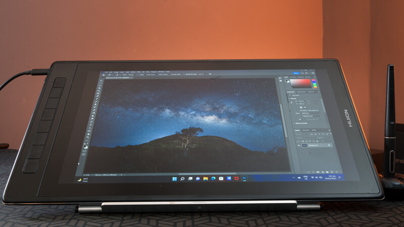 Wacom pen display tablet showing landscape photo editing in Photoshop with starry night sky.