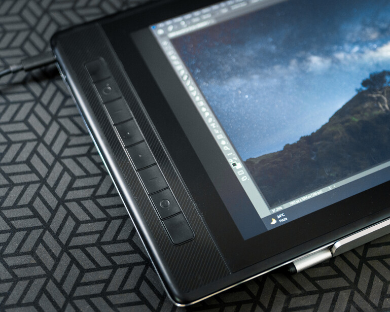 Tablet displaying landscape photography editing software with mountain scenery displayed on screen.