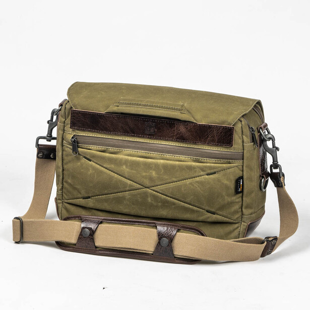 Olive canvas camera bag with brown leather accents and dual shoulder straps displayed against white background.