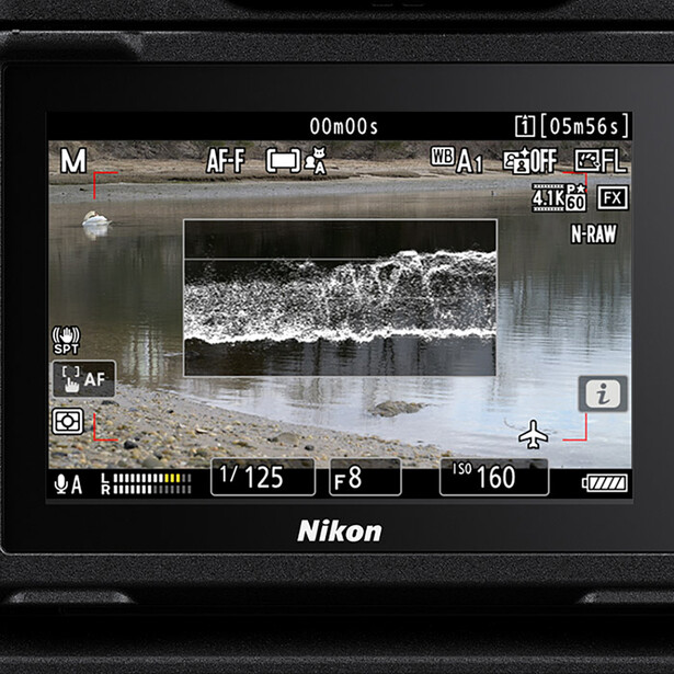 Screenshot of Nikon camera LCD screen displaying live view with waveform monitor overlay and exposure data.