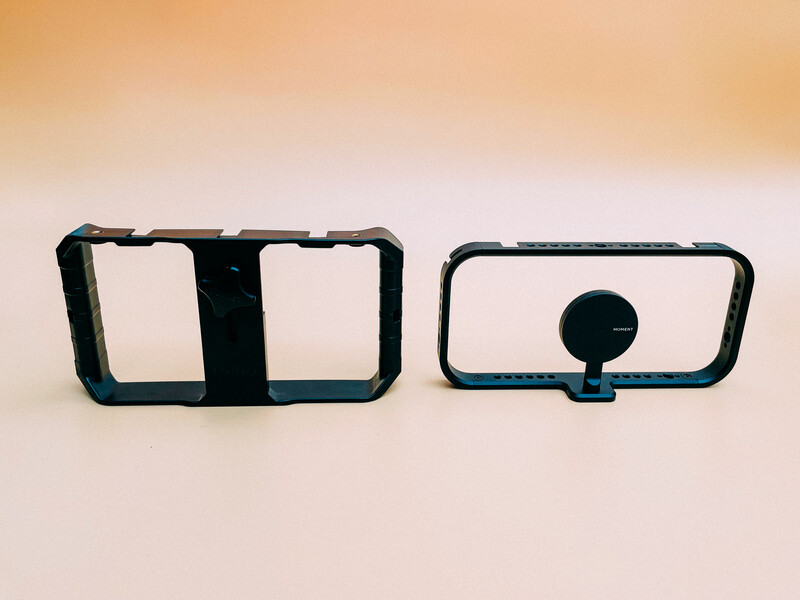 Two black smartphone cage rigs displayed side by side against a beige background.