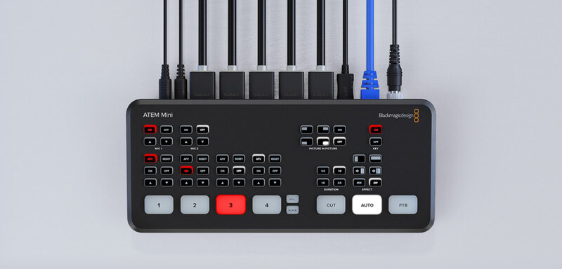 Blackmagic ATEM Mini production switcher with control panel buttons and cable connections on white background.