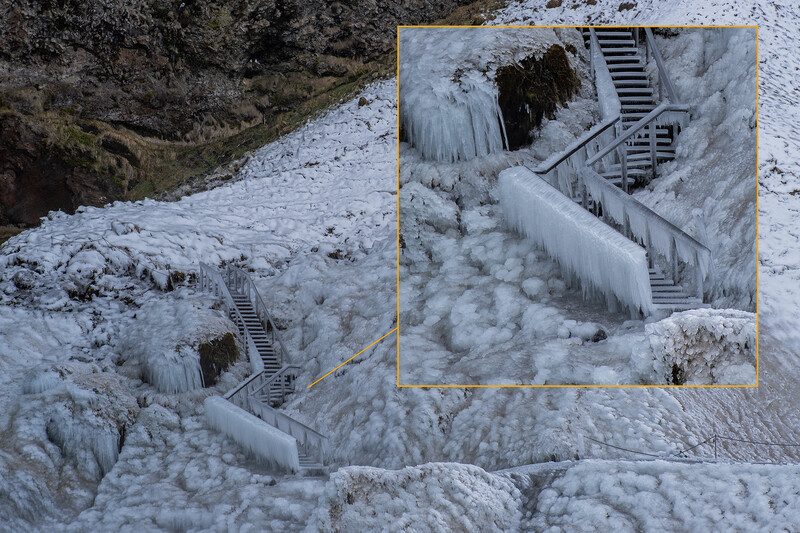 Frozen staircase cascading down an icy cliff face with snow and ice formations.